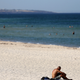 A man sits on a beach in Adelaide, Australia, on January 24, when temperatures soared north of 115 degrees Fahrenheit.